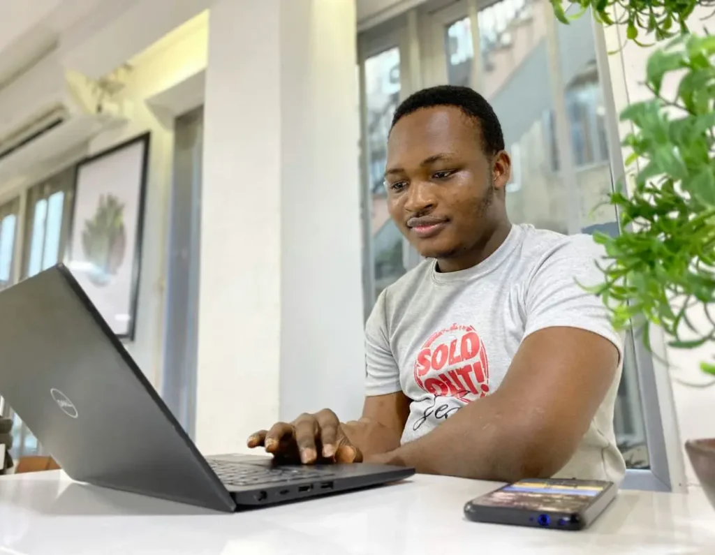 Nigerian remote worker using a laptop at home